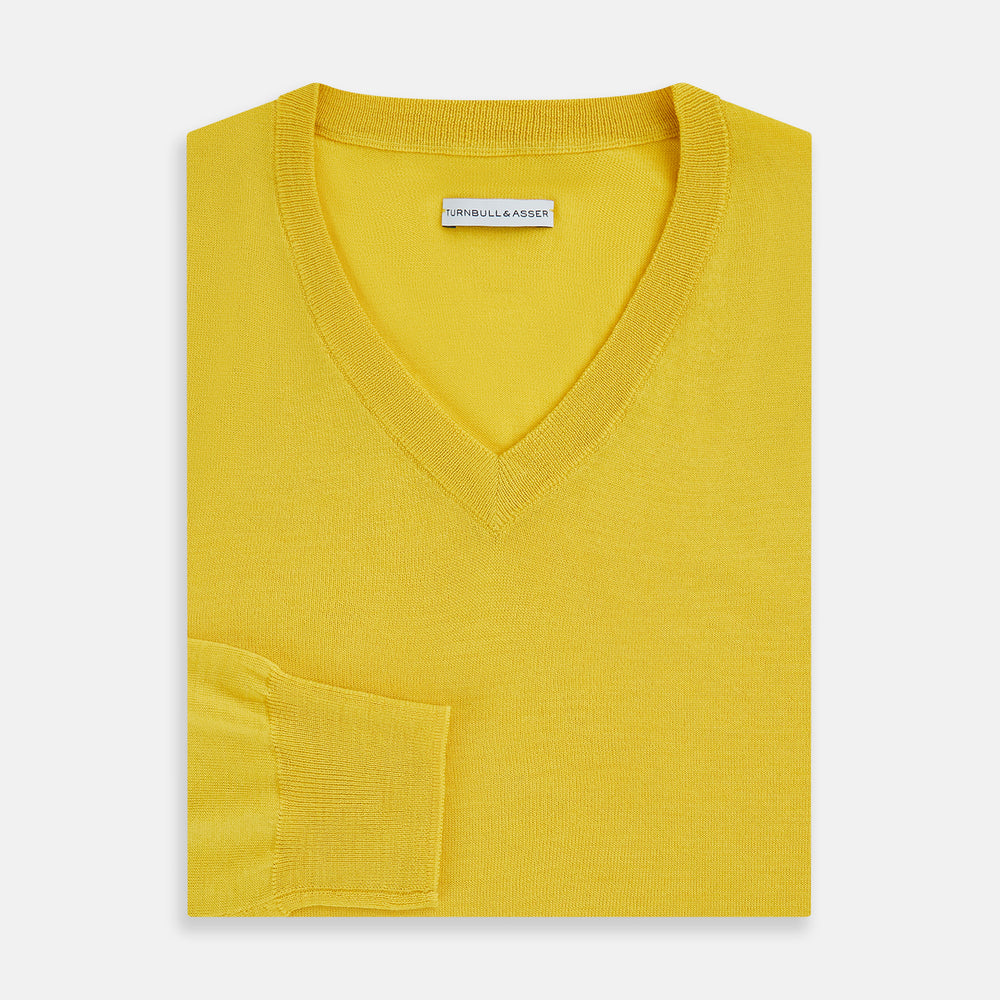 The Turnbull & Asser Canary Yellow Fine Merino V-Neck Jumper, crafted from soft knitwear, features long sleeves and is displayed on a white background.