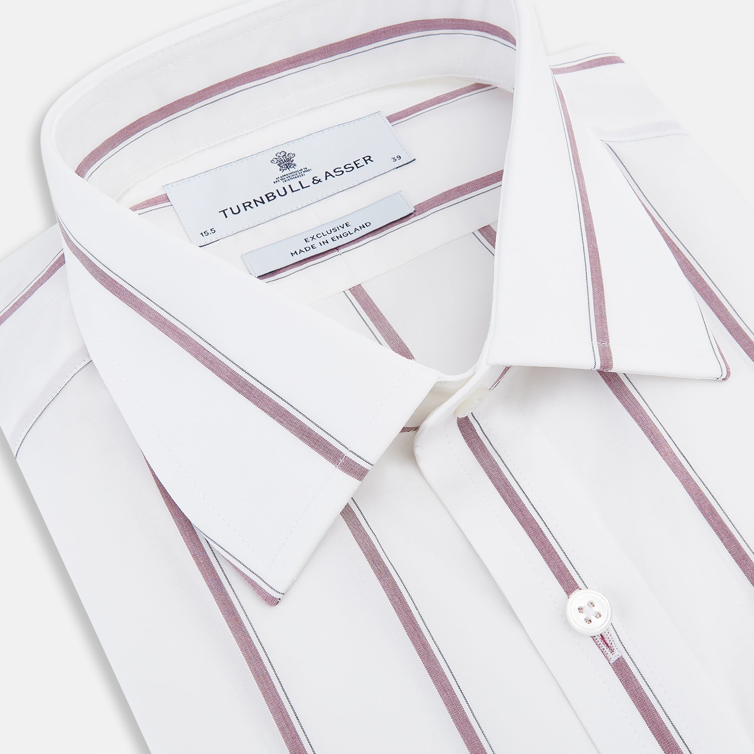 View 2 of product The Turnbull & Asser Wine Track Stripe Mayfair Shirt is a white long-sleeve shirt with vertical wine stripes and a pointed collar, crafted from premium Italian cotton and shown flat against a plain background.
