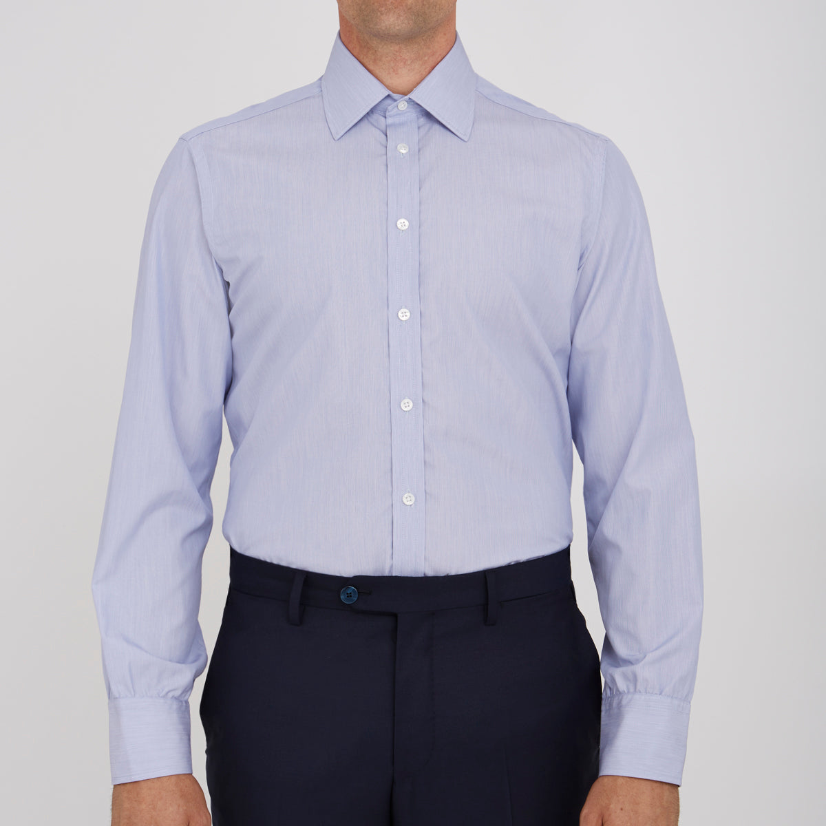 View 2 of product The Turnbull & Asser Blue Hairline Stripe Shirt features a T&A collar, 3-button cuffs, and subtle stripes, displayed neatly folded against a plain white background.