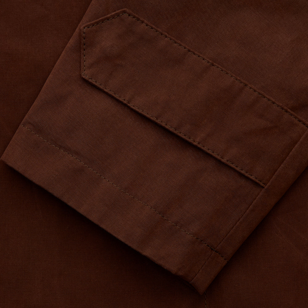 The Burgundy Grayson Car Coat by Turnbull & Asser, made from a rain-resistant cotton blend with a collar, hidden front buttons, and slanted pockets, is displayed flat on a white background in a minimalist style.