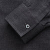 View 3 of product The Turnbull & Asser Charcoal Cotton Blend Weekend Fit Blake Shirt is a long-sleeve, stand-collar shirt with white buttons. Its minimalist design, with no pockets or patterns, makes it perfect for casual wear. Displayed flat on a white background.