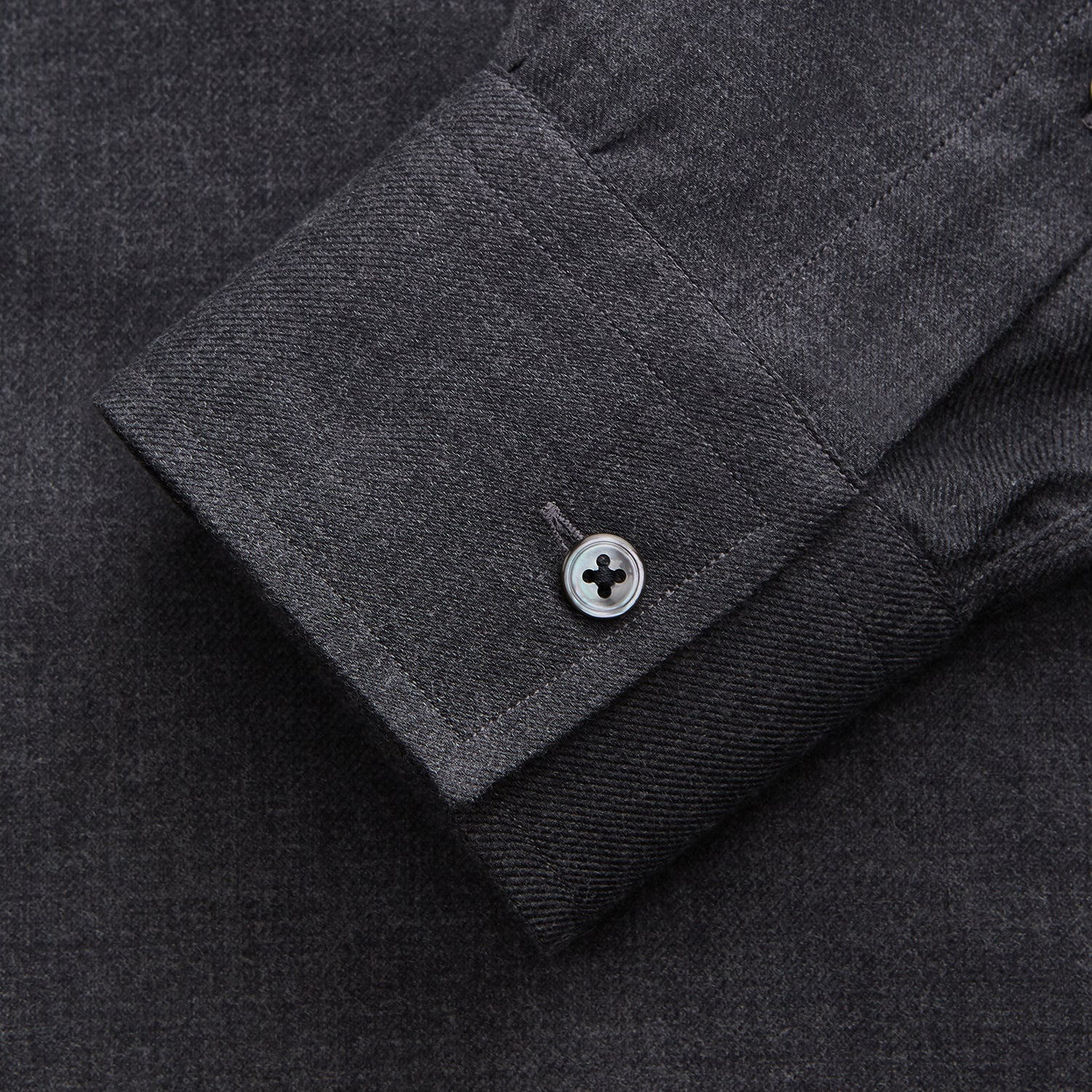 View 3 of product The Turnbull & Asser Charcoal Cotton Blend Weekend Fit Blake Shirt is a long-sleeve, stand-collar shirt with white buttons. Its minimalist design, with no pockets or patterns, makes it perfect for casual wear. Displayed flat on a white background.