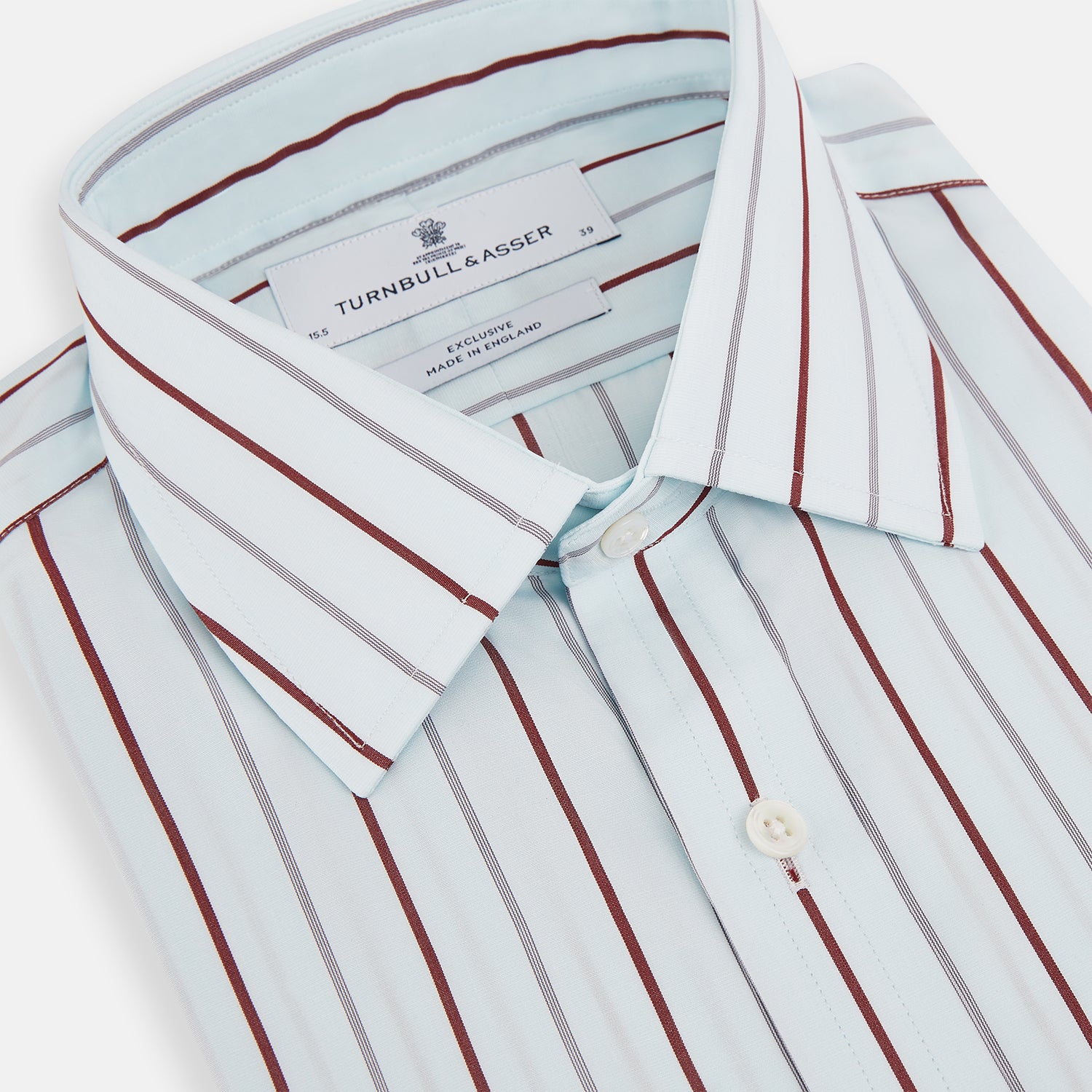 View 2 of product The Turnbull & Asser Burgundy Combination Stripe Mayfair Shirt features long sleeves, a classic T&A collar, and vertical black and burgundy stripes on white, laid flat against a plain white background.