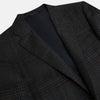 View 2 of product The Turnbull & Asser Charcoal Glen Check Sports Jacket features a dark plaid pattern, single-button closure, notched lapels, and two front flap pockets, shown against a plain white background—an essential for any men's wardrobe.