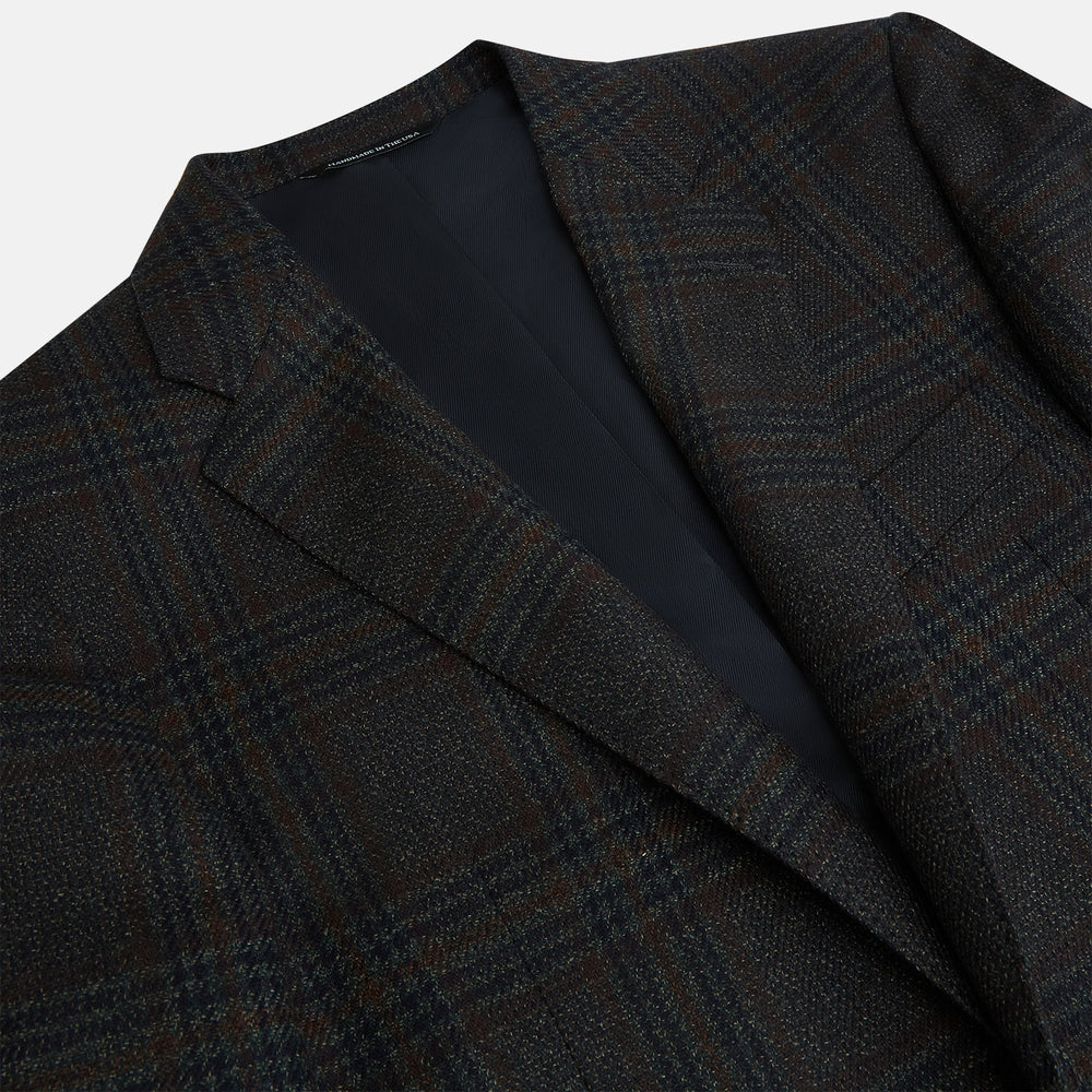 The Turnbull & Asser Charcoal Glen Check Sports Jacket features a dark plaid pattern, single-button closure, notched lapels, and two front flap pockets, shown against a plain white background—an essential for any men's wardrobe.