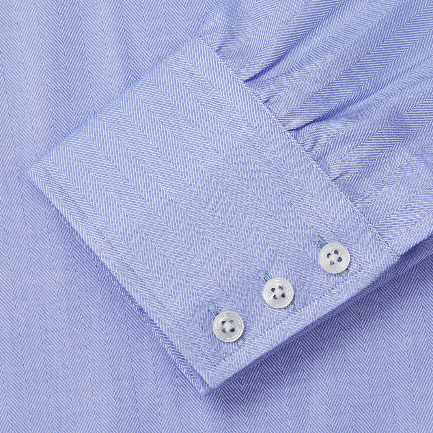 View 3 of product The Turnbull & Asser Blue Herringbone Regular Fit Shirt features a classic Kent collar, long sleeves, white buttons, and buttoned cuffs. Displayed on a white background, it's the perfect formal shirt for any occasion.