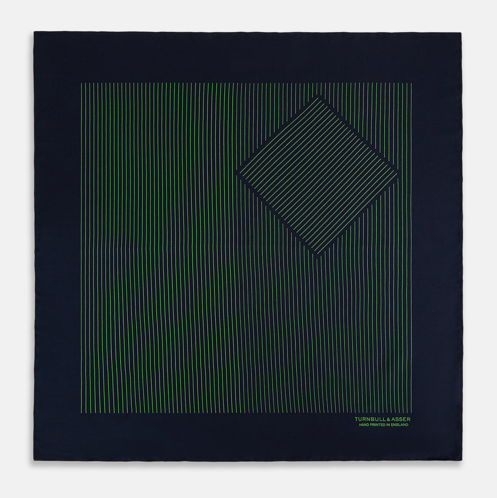 The Navy and Fern Green Stripe Silk Pocket Square by Turnbull & Asser features green vertical and diagonal stripes, hand-rolled edges, and "TURNBULL & ASSER HAND PRINTED IN ENGLAND" printed in one corner.