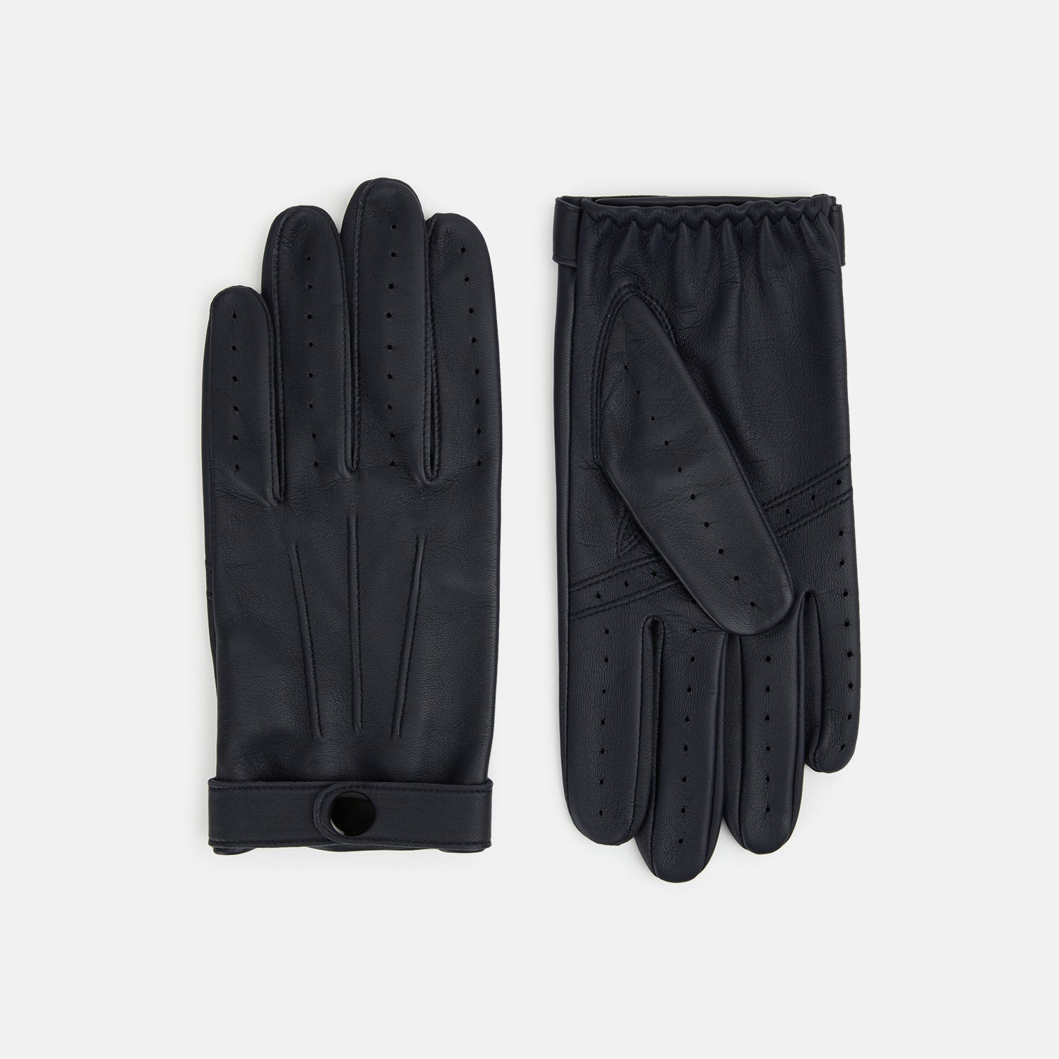 View 1 of product A pair of Navy Hairsheep Leather Touchscreen Driving Gloves by Turnbull & Asser is displayed, one palm up and one palm down. Crafted in Britain, the gloves feature vent holes, decorative stitching, and a snap button closure.