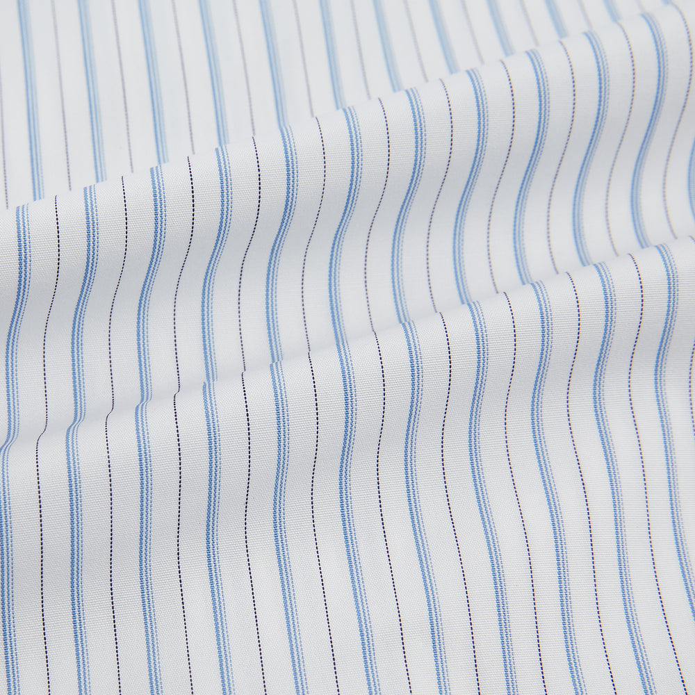 The Turnbull & Asser Sky Blue Combination Stripe Mayfair Shirt features long sleeves, a T&A collar, buttoned cuffs, and thin vertical stripes in blue, shown on a plain white background.