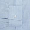 View 3 of product The Turnbull & Asser Pale Blue Cotton Cashmere Derby Collar Richmond Shirt features a soft cotton-cashmere blend, derby collar, white buttons, left chest pocket, and buttoned cuffs, shown laid flat on a white background.