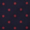 View 3 of product The EMBLEM SPOT NAVY TULIP TIE by Turnbull & Asser features a navy base with red circle motifs, neatly rolled on a white background—an essential accessory for refined style.