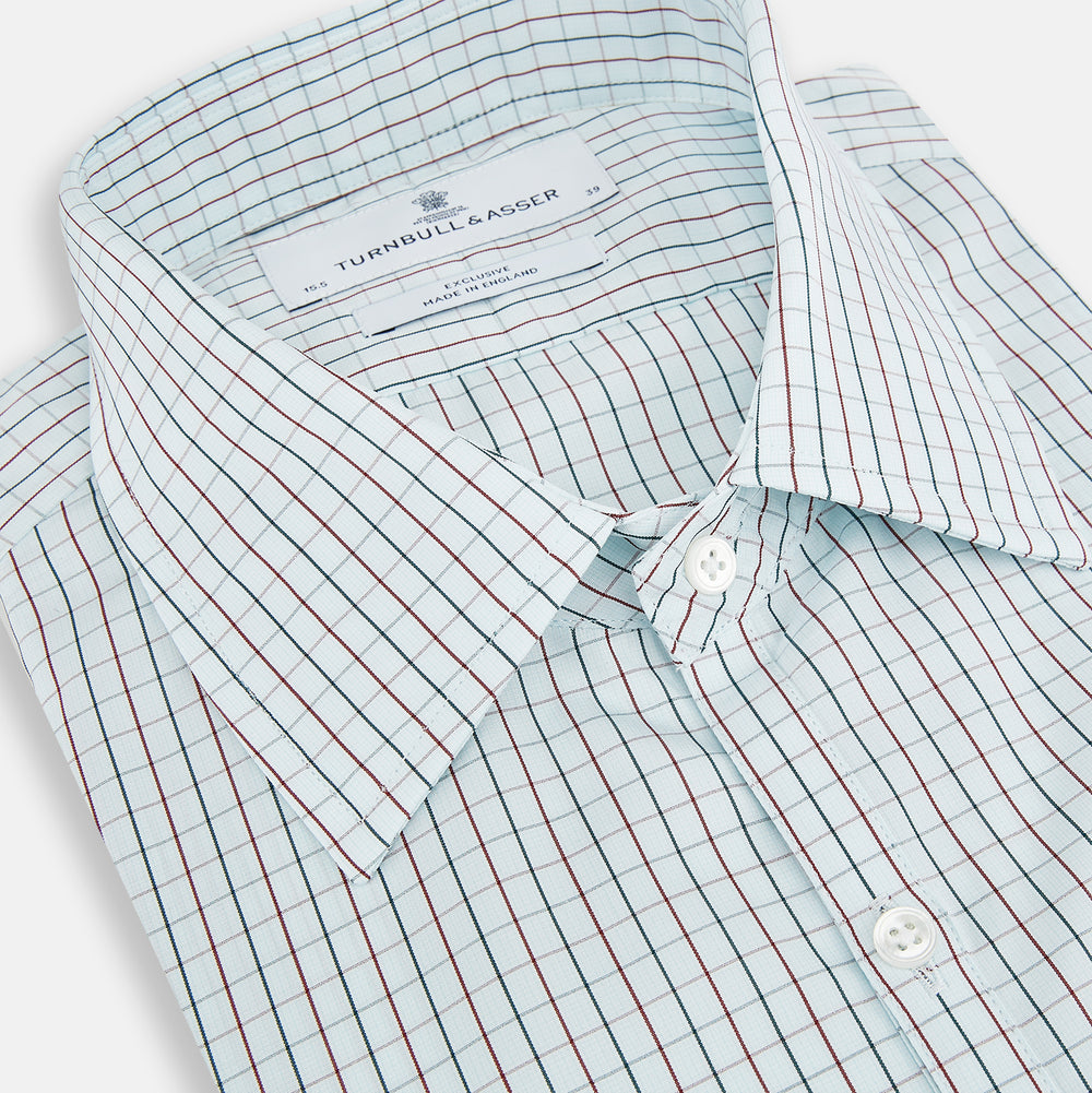 The Turnbull & Asser Forest Melange and Red Overlay Grid Check Westminster Shirt features long sleeves, a pointed collar, and buttoned cuffs, highlighting British craftsmanship. It's shown laid flat against a white background.