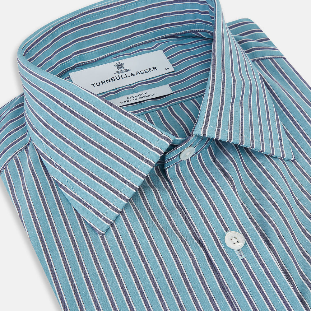 The Turnbull & Asser Turquoise Ticking Stripe Mayfair Shirt is a long-sleeve, button-up shirt in fine Italian cotton with light blue and white stripes, a collar, white buttons, curved hem, and subtle turquoise ticking stripe.