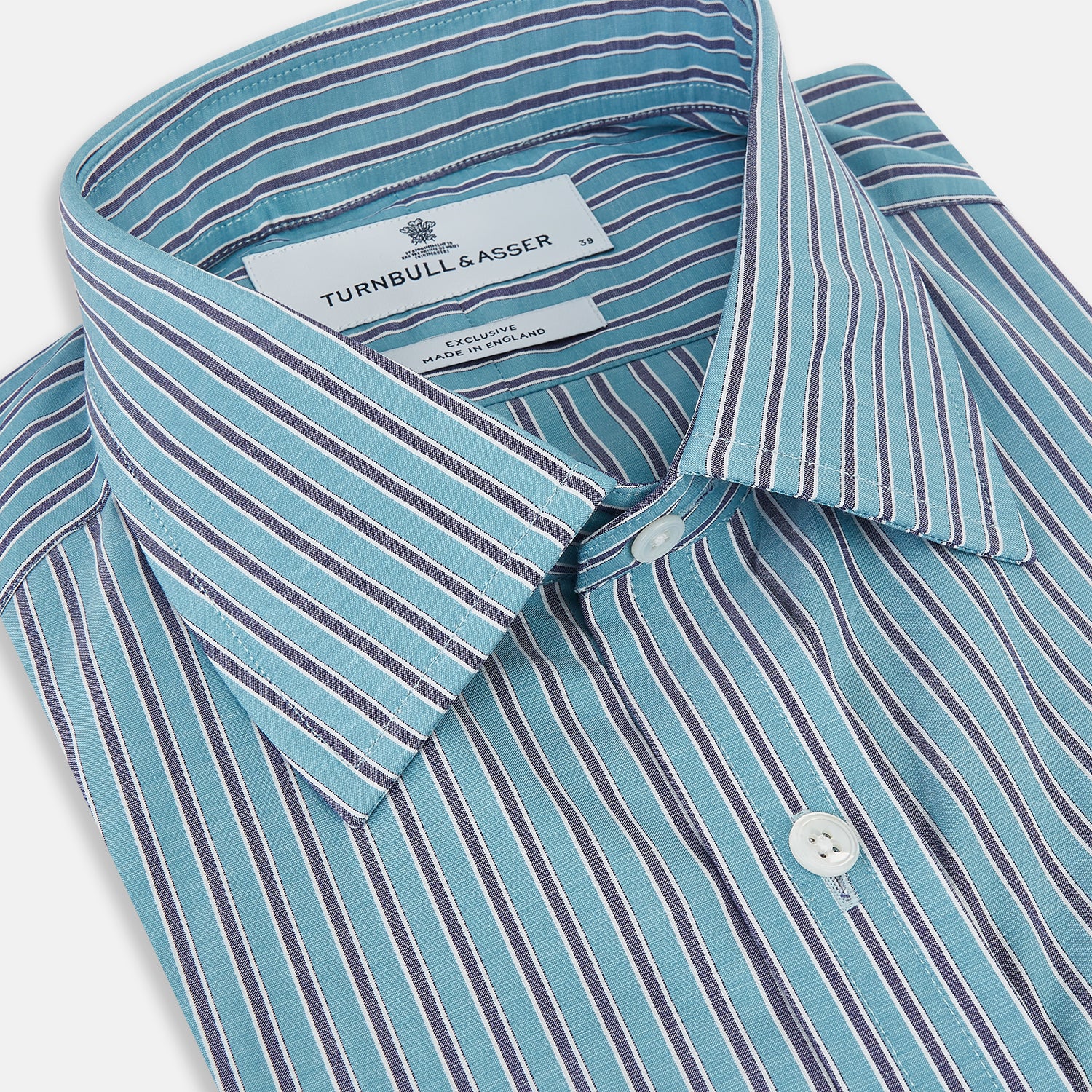 View 2 of product The Turnbull & Asser Turquoise Ticking Stripe Mayfair Shirt is a long-sleeve, button-up shirt in fine Italian cotton with light blue and white stripes, a collar, white buttons, curved hem, and subtle turquoise ticking stripe.