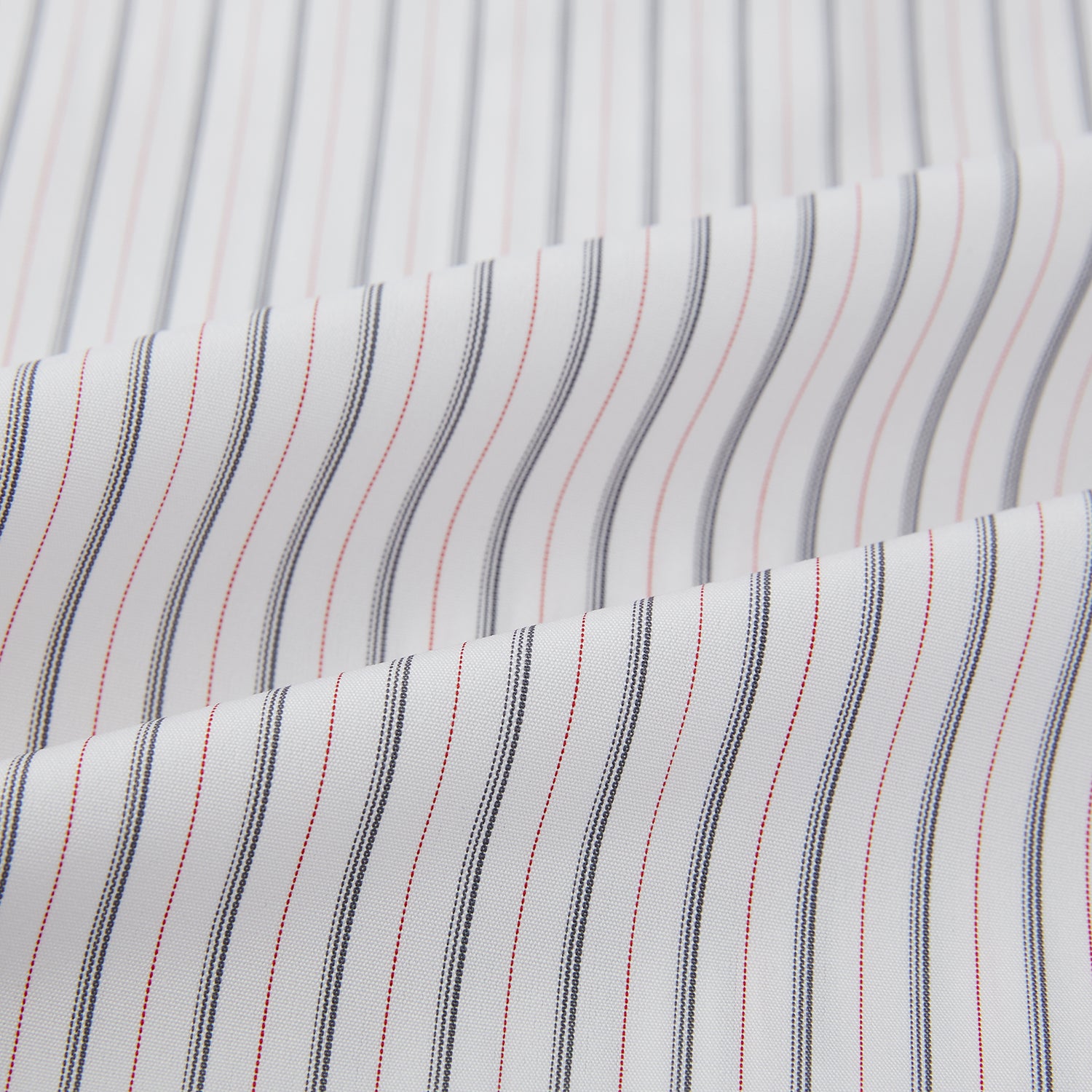 View 6 of product The Turnbull & Asser Midnight Blue and Red Ticking Stripe Mayfair Shirt features long sleeves, a pointed collar, buttoned cuffs, and fine Italian cotton—an essential men's wardrobe piece shown on a plain white background.