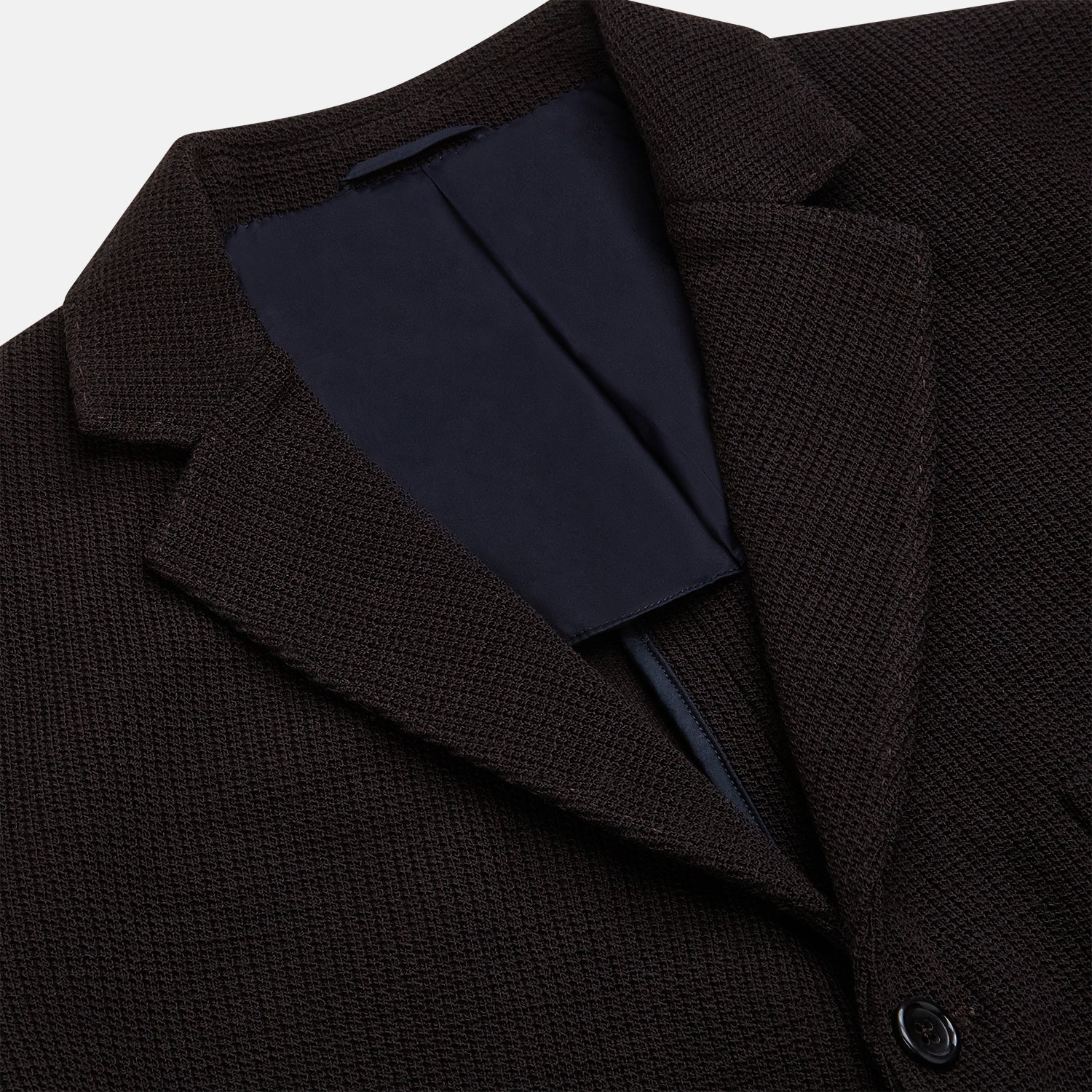 View 2 of product The Turnbull & Asser Dark Chocolate Knitted Cambridge Blazer for men, made from fine Italian wool with British tailoring, features a notched lapel, three front buttons, and three patch pockets, shown on a plain white background.