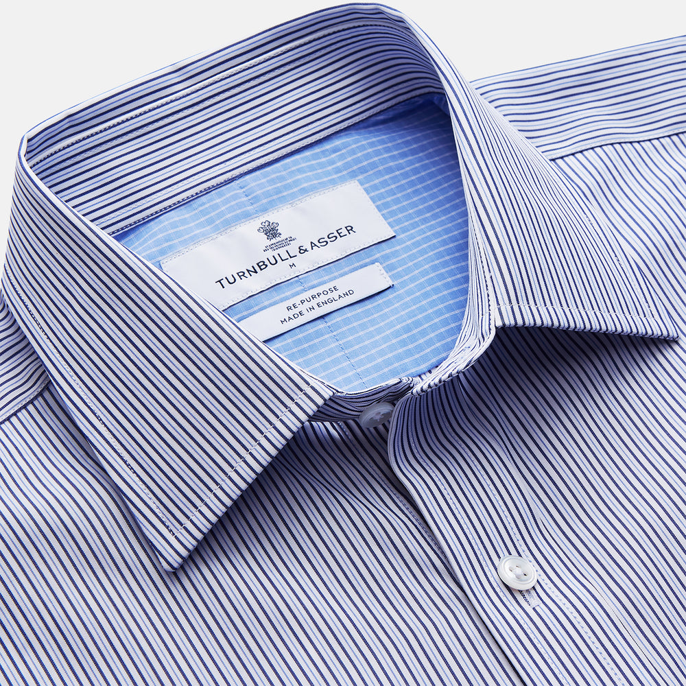 The Turnbull & Asser Blue Multi Stripe Cotton RE-PURPOSE Weekend Fit Finch Shirt features thin blue and white stripes, a contrasting light blue checkered chest pocket, and is crafted sustainably using recycled fabrics.