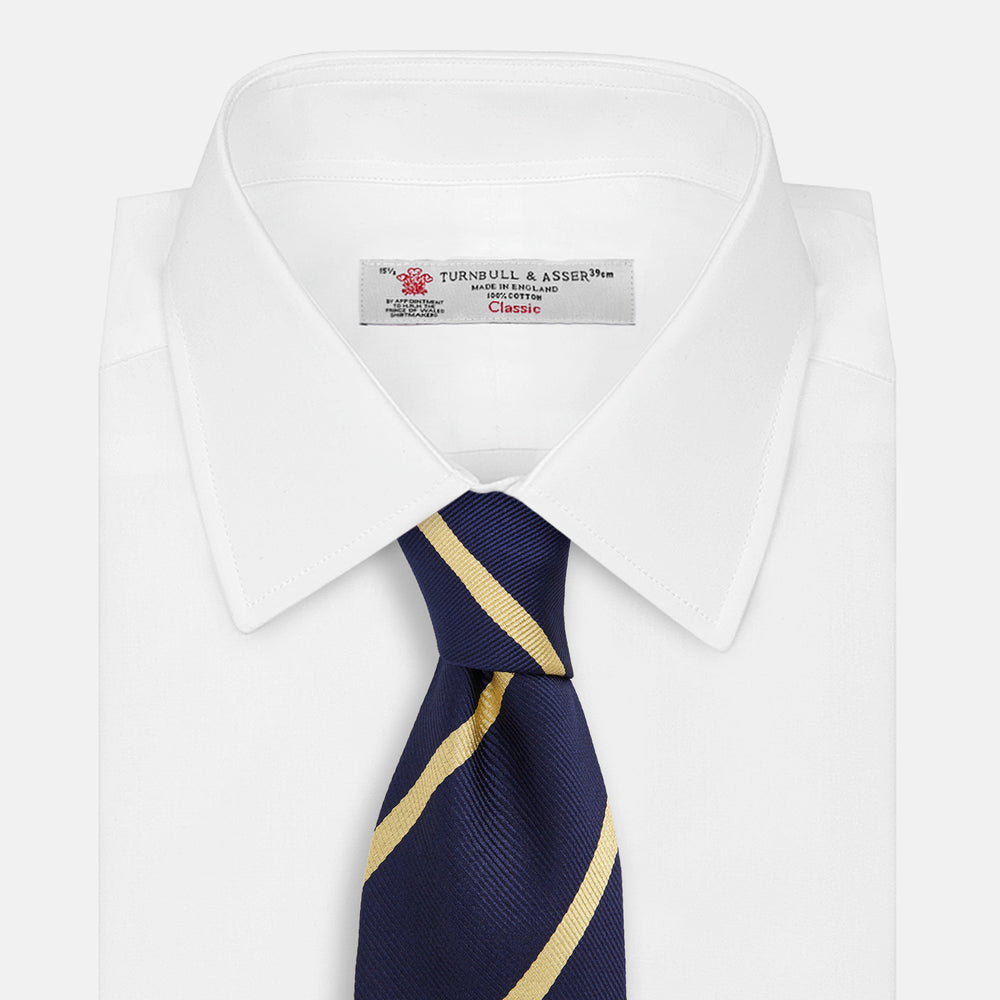 The Turnbull & Asser BLAZER STRIPE NAVY LEO TIE features classic navy with diagonal yellow stripes—an essential accessory to elevate any smart outfit.