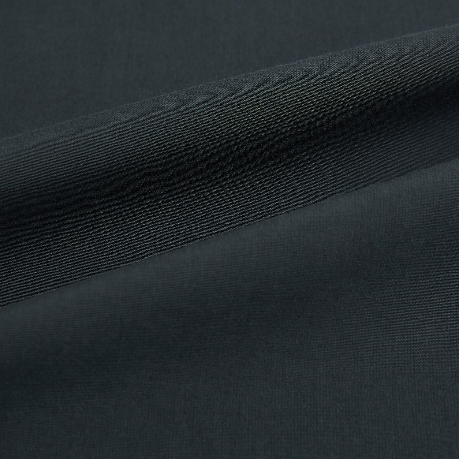 View 8 of product The Charcoal Windsor Shirt by Turnbull & Asser is a black, long-sleeve button-up with a pointed Windsor collar, buttoned cuffs, and a straight hem, shown flat on a white background.