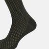 View 4 of product A single Forest Green Motif Long Sock from Turnbull & Asser, crafted from soft mercerised Egyptian cotton, features a subtle pattern, ribbed cuff, and left-foot shaping, displayed on a light background.
