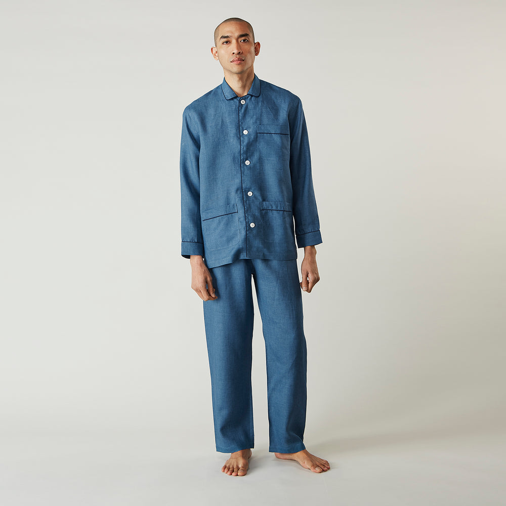 A person stands barefoot against a plain background, wearing the Teal Linen Modern Pyjama Set from Turnbull & Asser.