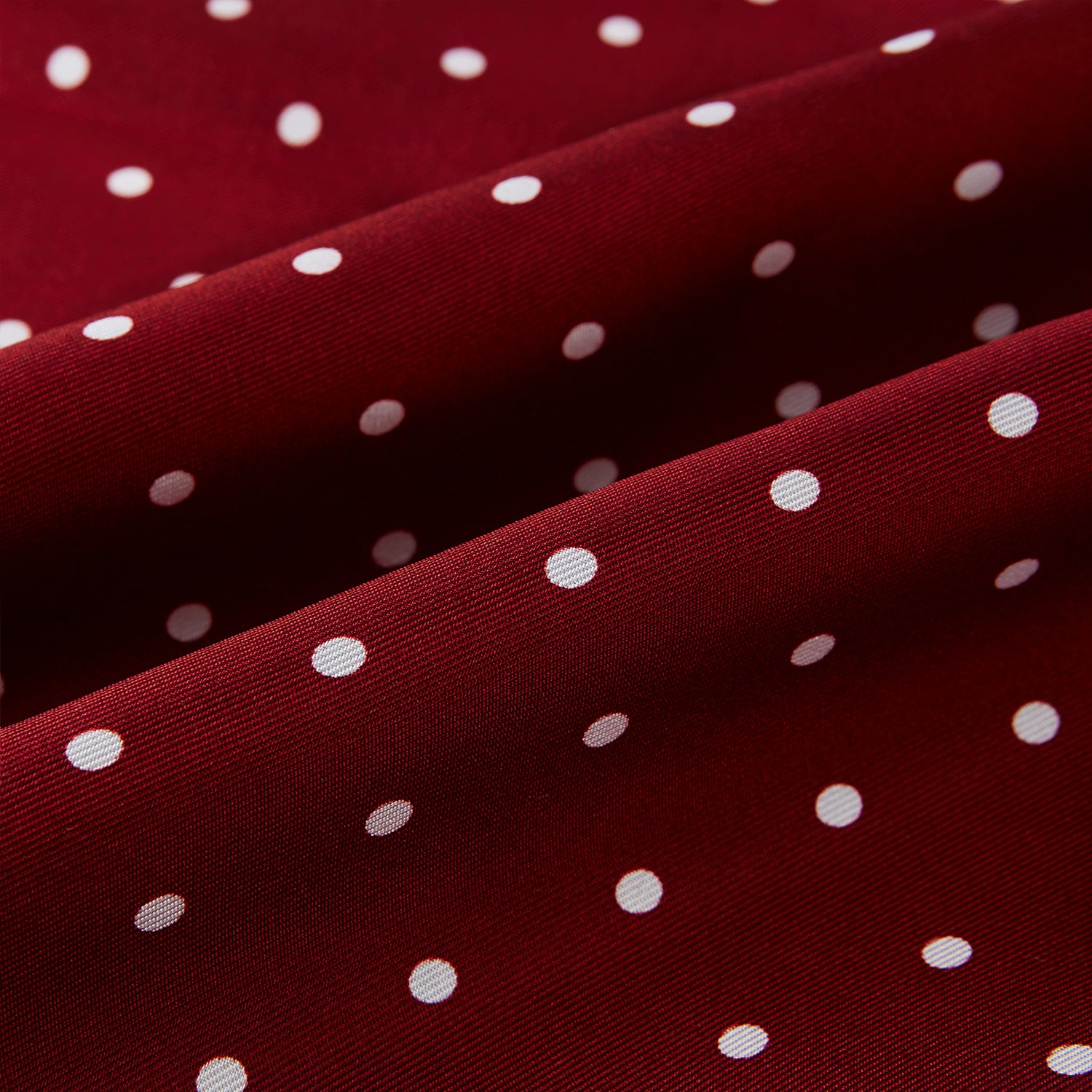 View 3 of product The Burgundy and White Spotted Silk Scarf by Turnbull & Asser features a gradient of white polka dots, short fringed edges, and the brand's name near the ends—a timeless classic foulard.