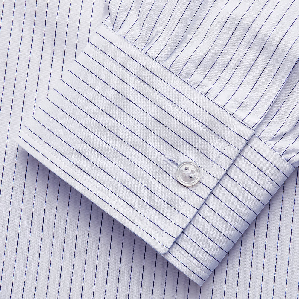 The White and Blue Stripe Cotton RE-PURPOSE Weekend Fit Finch Shirt by Turnbull & Asser features long sleeves, thin blue stripes, a light blue chest pocket, and is crafted sustainably.