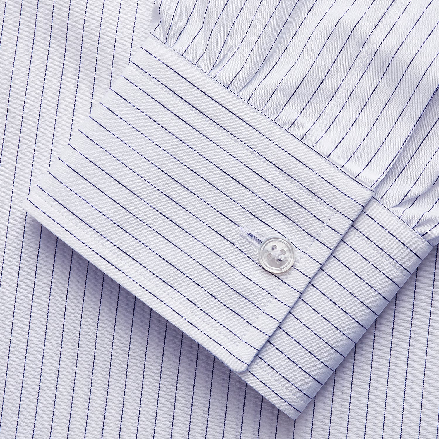 View 4 of product The White and Blue Stripe Cotton RE-PURPOSE Weekend Fit Finch Shirt by Turnbull & Asser features long sleeves, thin blue stripes, a light blue chest pocket, and is crafted sustainably.