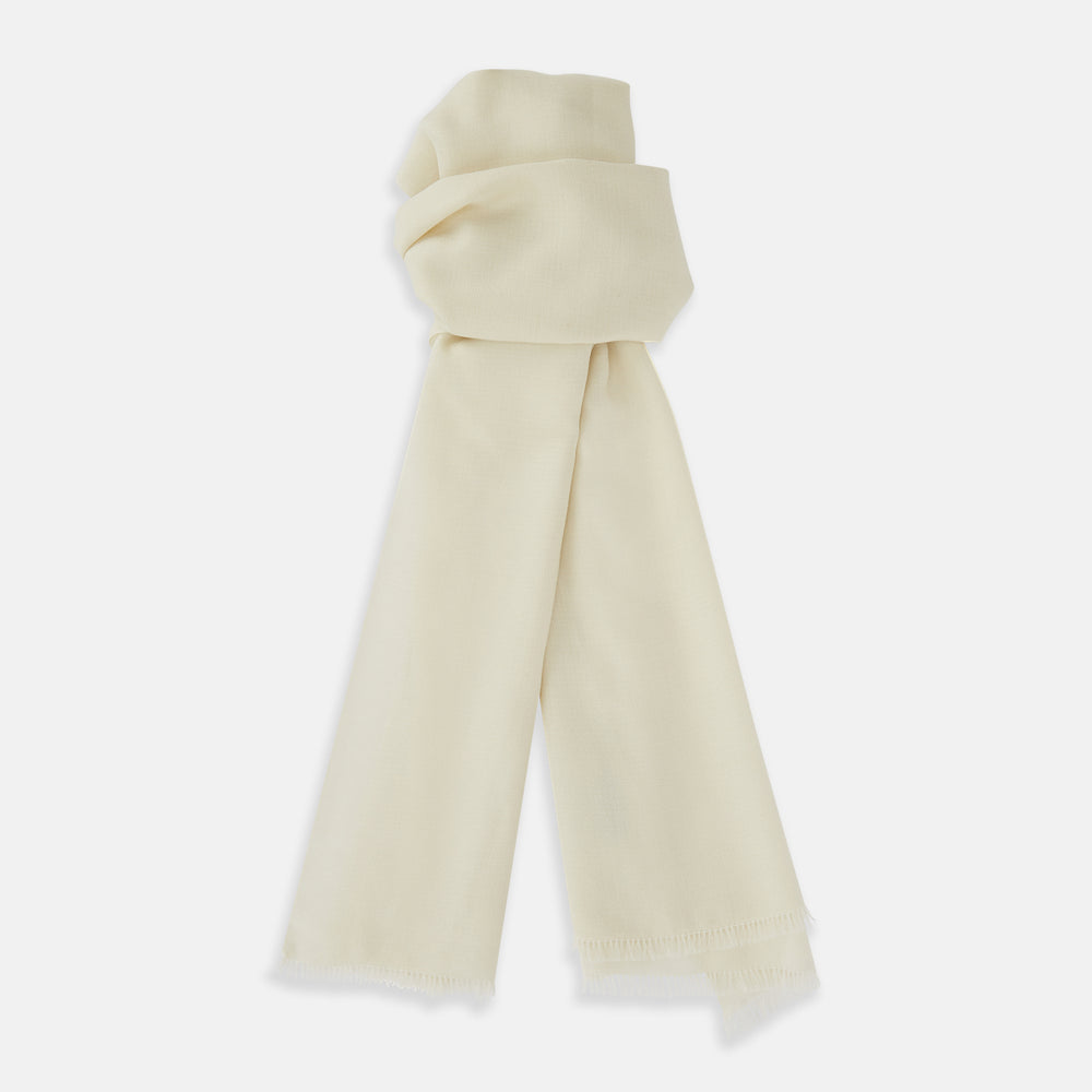 The Turnbull & Asser White Cashmere Scarf features a soft, cream-colored lightweight texture and fringed edges, elegantly displayed on a white background—ideal for adding sophistication to eveningwear.