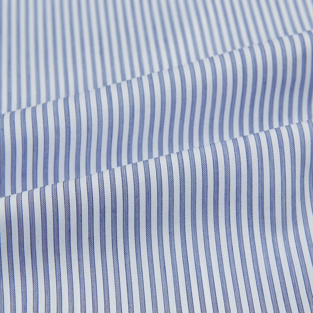 The Turnbull & Asser Navy and White Stripe Westminster Shirt features thin vertical stripes, a Turnbull collar, long sleeves, and classic British craftsmanship, shown flat on a white background.
