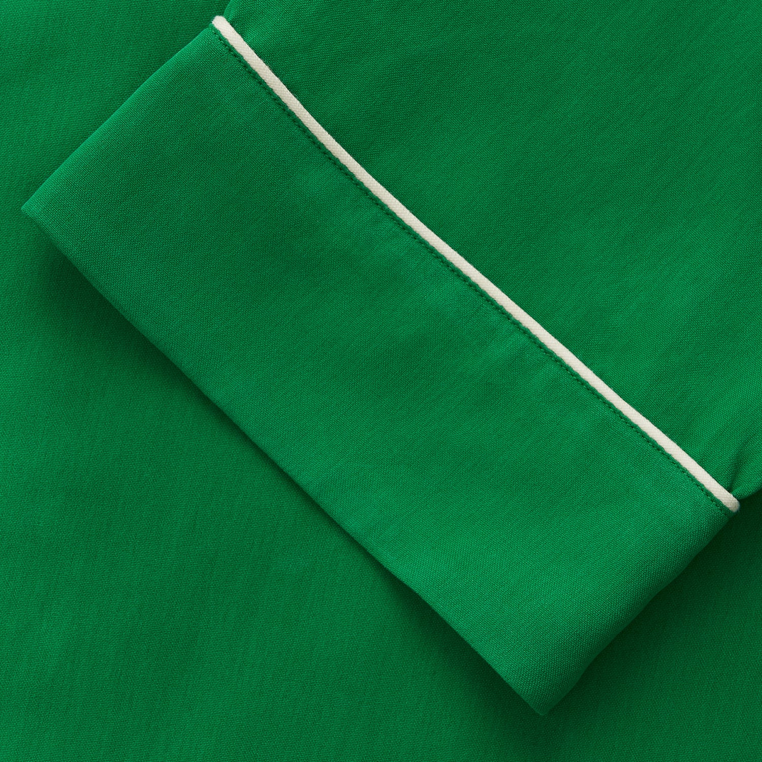 View 3 of product The Turnbull & Asser Green Silk Hyde Pyjamas Set features a long-sleeve button-up top with three pockets and modern fit elastic waistband pants in silk blend, both shown laid flat on a white background.