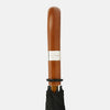 View 5 of product The Turnbull & Asser Black Traveller Umbrella features a Malacca crook handle and straight wooden shaft—a timeless accessory displayed fully opened against a white background.