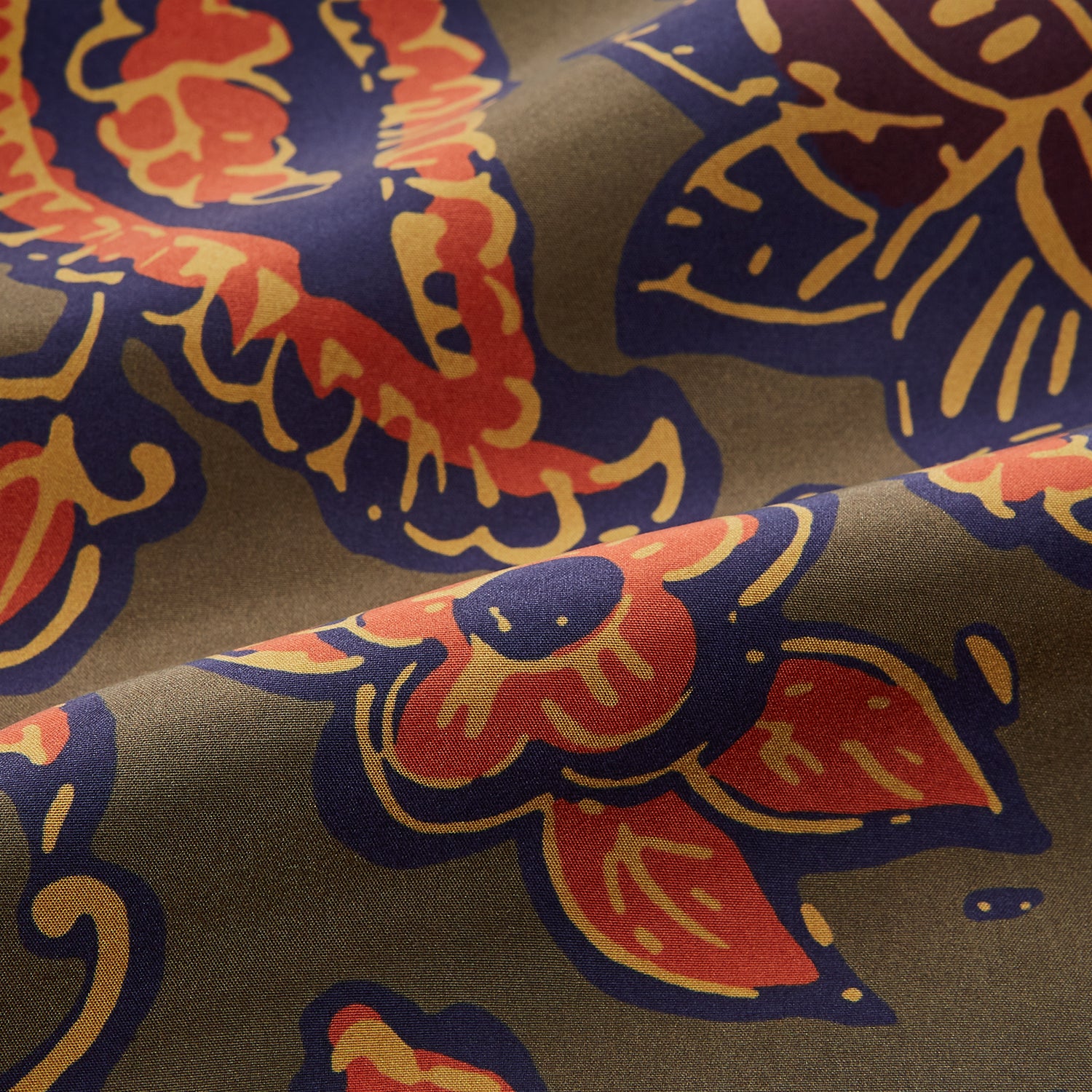 View 3 of product The Turnbull & Asser Khaki Green Floral Silk Holiday Fit Winnington Shirt features a bold floral print with orange, yellow, and purple on an olive background, plus a spread collar and chest pocket for versatile style.