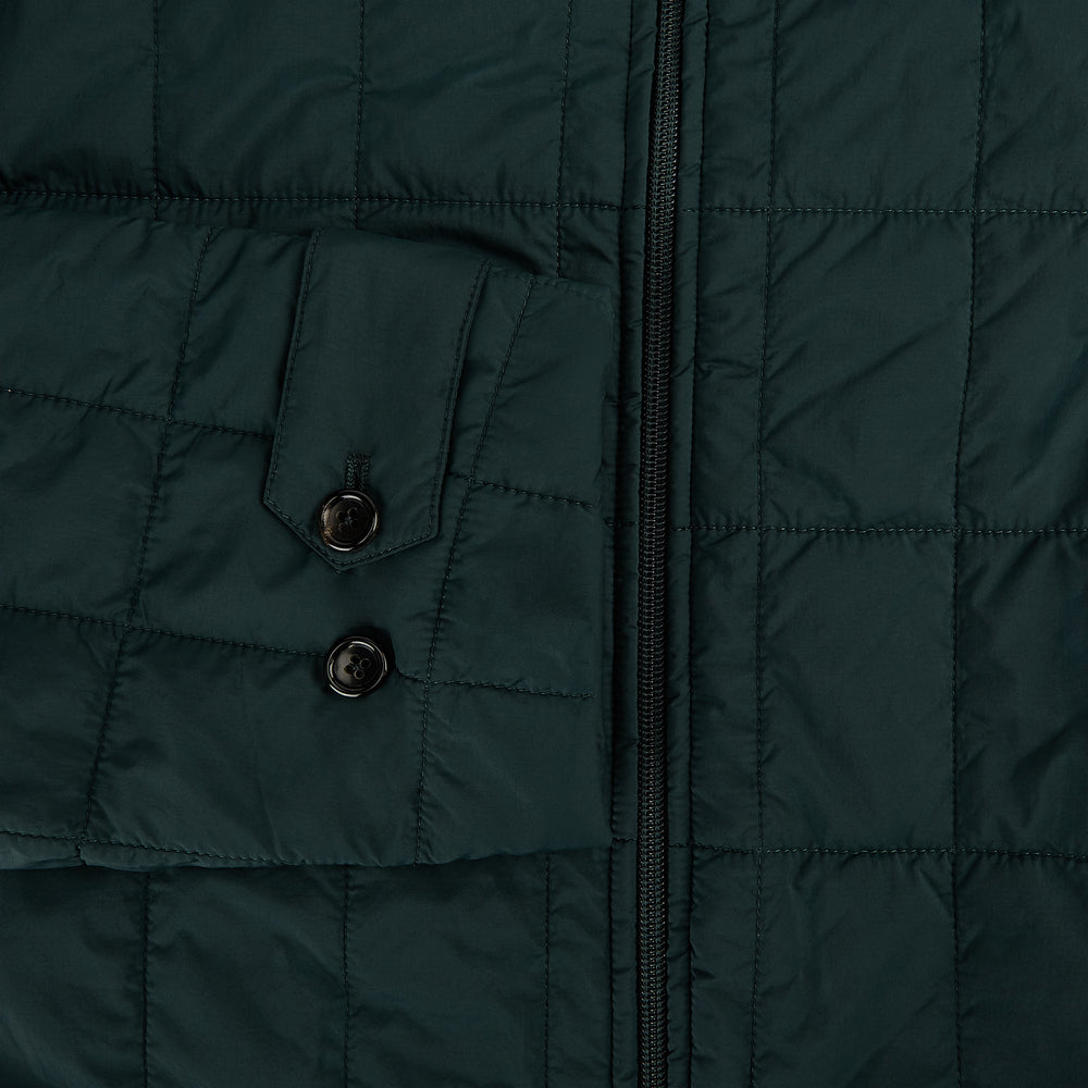 The Turnbull & Asser Battersea Forest Green Quilted Jacket for men features a front zipper, collared neckline, angled chest pocket, two zippered side pockets, and adjustable snap cuffs—shown on a plain white background.