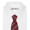 View 2 of product The Turnbull & Asser GGT92000 3042 48 OS is a rolled-up red cotton silk stripe tie with diagonal white and navy blue stripes, displayed on a plain white background.