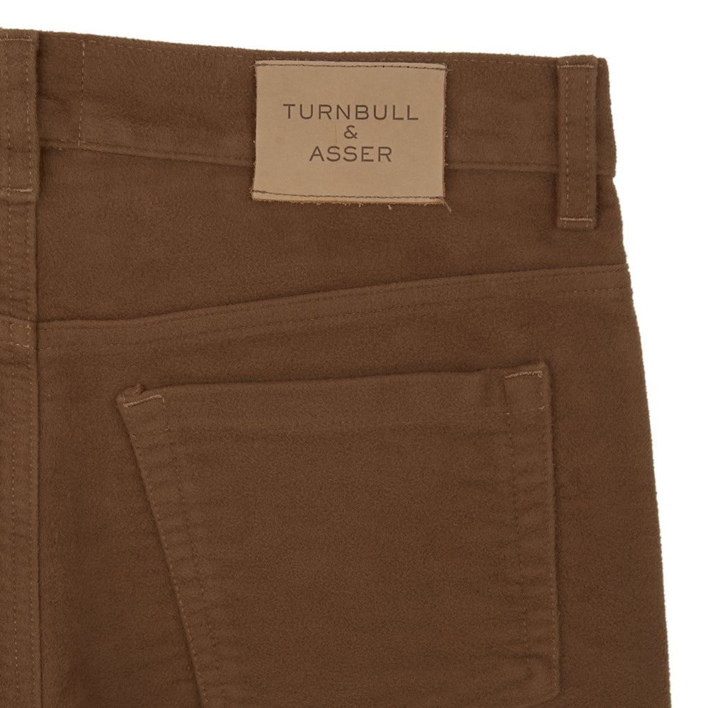A pair of yellow cotton plain 5 pocket jeans by Turnbull & Asser, featuring a button and zip closure, displayed on a plain white background.