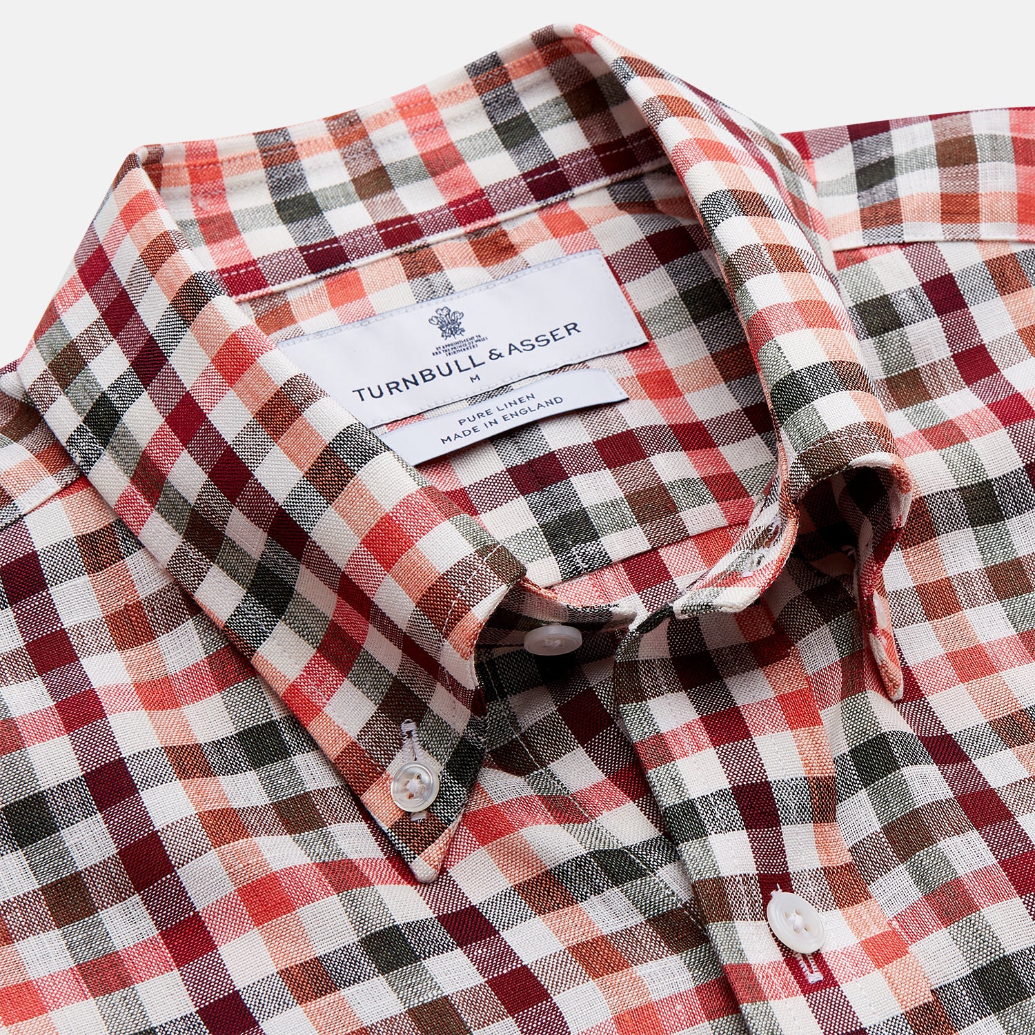 View 2 of product The Turnbull & Asser Red and Green Check Linen Blend Weekend Fit Hayne Shirt features a classic plaid pattern in red, white, black, and green, with a Dorset button-down collar and long sleeves. Displayed on a white background.