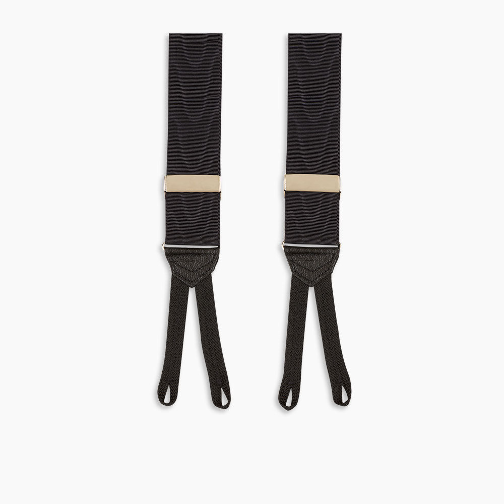 Turnbull & Asser Black Adjustable Formal Braces featuring leather ends and beige metal adjusters, made in England, shown on a white background.