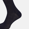 View 4 of product A single navy long sock by Turnbull & Asser, featuring a subtle ribbed texture and crafted from soft Egyptian cotton, displayed on a plain white background.