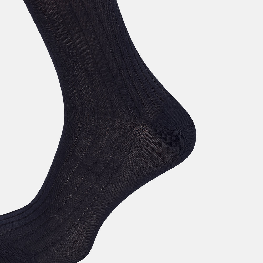 A single navy long sock by Turnbull & Asser, featuring a subtle ribbed texture and crafted from soft Egyptian cotton, displayed on a plain white background.