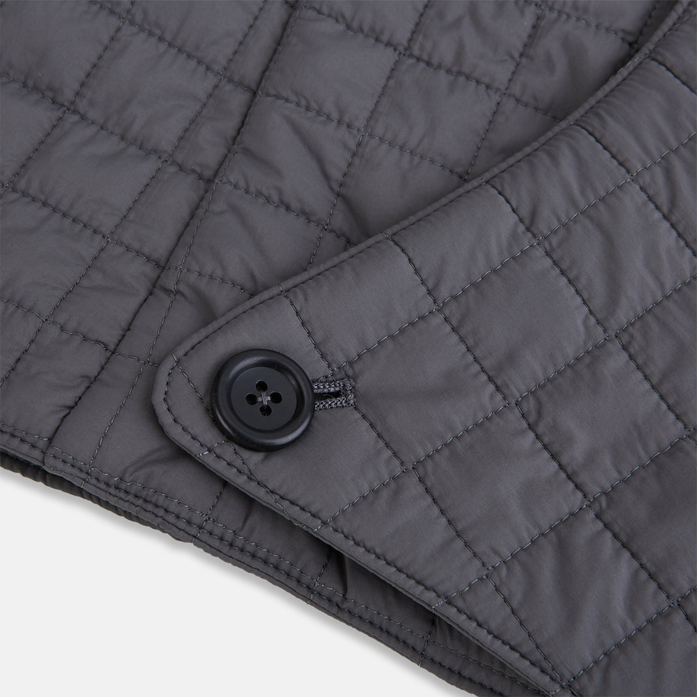 The Turnbull & Asser Shadow Grey Quilted Hood with Neck Warmer features a button closure, inspired by quilted jacket hoods, and is displayed on a plain white background.