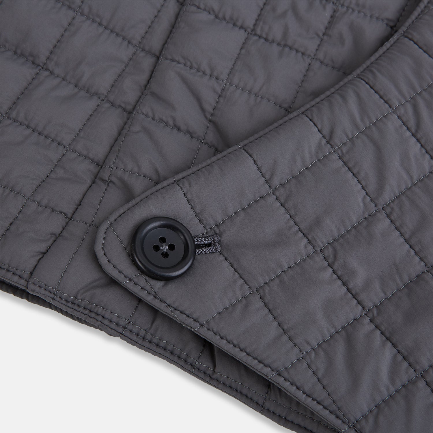 View 5 of product The Turnbull & Asser Shadow Grey Quilted Hood with Neck Warmer features a button closure, inspired by quilted jacket hoods, and is displayed on a plain white background.