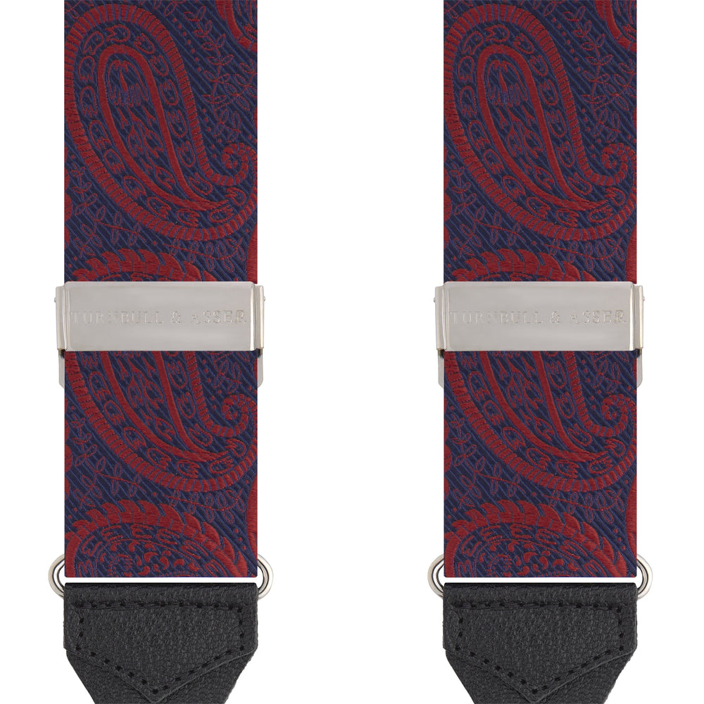 Two Red Jacquard Silk Paisley Braces by Turnbull & Asser, featuring black leather ends and silver-tone buckles, are displayed side by side on a plain white background.