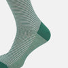View 4 of product The Turnbull & Asser Ivory Houndstooth Mid-Length Sock features a green and white houndstooth pattern with solid green cuff, heel, and toe accents. Displayed on a plain white background.