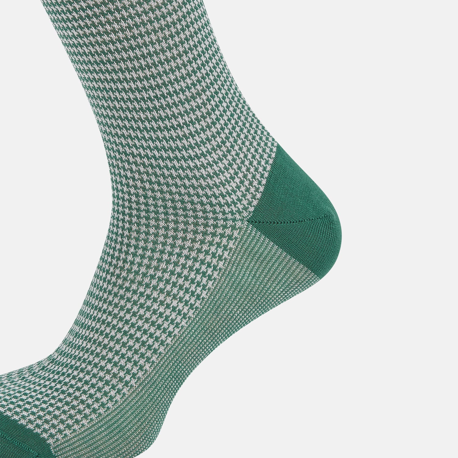 View 4 of product The Turnbull & Asser Ivory Houndstooth Mid-Length Sock features a green and white houndstooth pattern with solid green cuff, heel, and toe accents. Displayed on a plain white background.