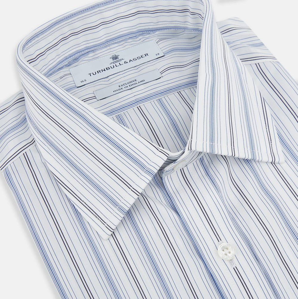 The Turnbull & Asser Navy and Blue Multi Stripe Mayfair Shirt features long sleeves, a T&A collar, and buttoned cuffs, shown against a white background.