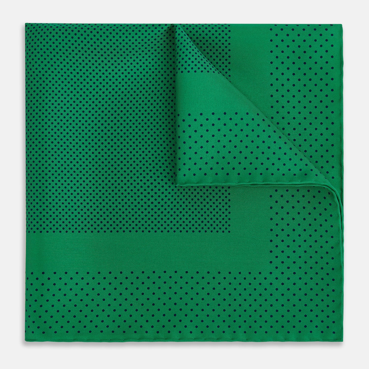 View 1 of product The Turnbull & Asser Green Dot Silk Pocket Square is handmade in England and shown neatly folded, revealing the front and part of the underside against a white background.