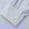 View 3 of product The Turnbull & Asser Blue and Yellow Stripe Poplin Cotton Nightshirt features light blue and yellow vertical stripes, long sleeves, a classic collar, single chest pocket, rounded hem, and is displayed flat on a white background.