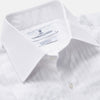 View 2 of product The Turnbull & Asser White Pleated Cotton Dress Shirt features a T&A collar and double cuffs, shown laid flat on a white background.
