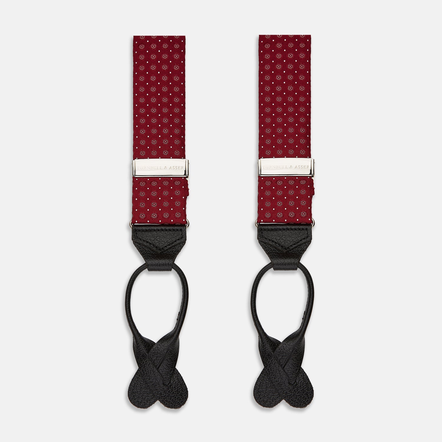 View 1 of product The Turnbull & Asser Burgundy Assorted Braces feature small white dots, silver adjusters, and black leather loops—a timeless accessory for the traditional gentleman.